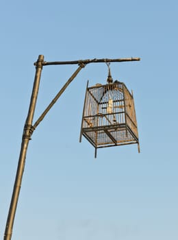 Birdcage lamp in blue sky