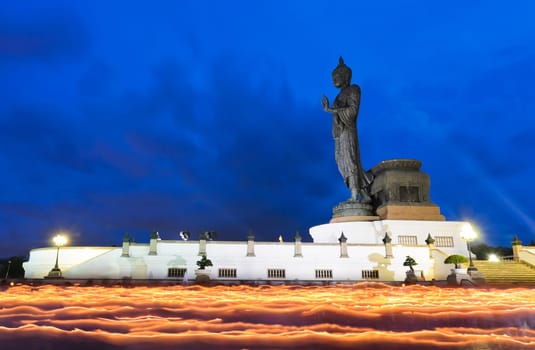 Candle light trail of Buddhism Ceremony. Walking with lighted candles around buddha statue, Thailand