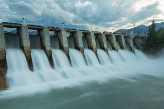 Wide shot time exposure of the spillway on the Kananaskis hydroelectric dam on the Bow River, Alberta, Canada