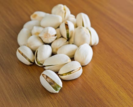 Roasted shelled pistachio on wooden background