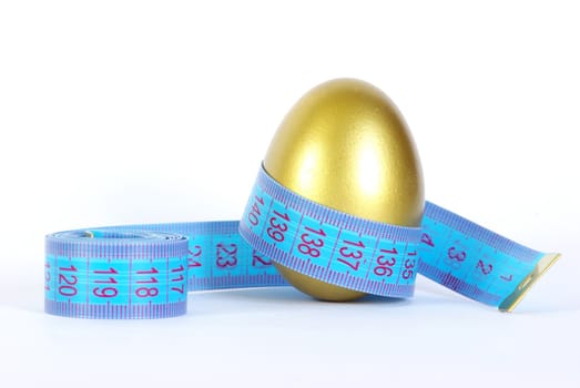 gold egg with measuring tape  around