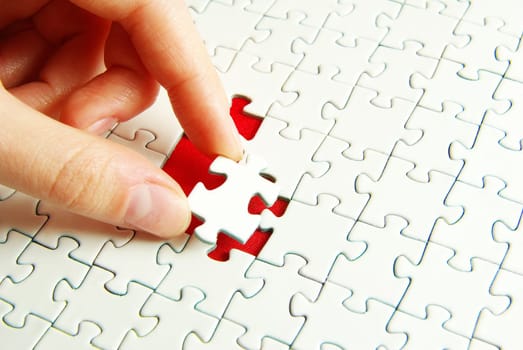 hands holding a puzzle piece . business concepts