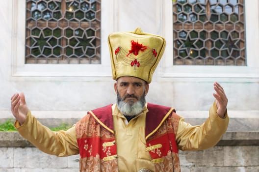 turkish man in ancient oriental costume in istanbul. He got paid by tourists who want to take pictures