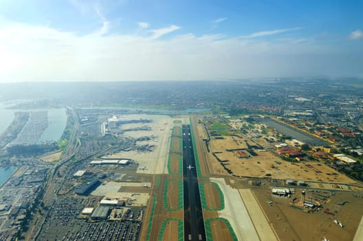 Aerial view of the San Diego International Airport, river and pacific ocean, in Southern California. Lindbergh Field is the busiest single runway commercial airport in the United States of America.