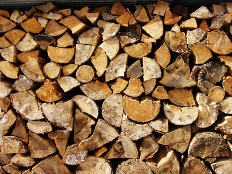 Stack of wood in backyard of a house