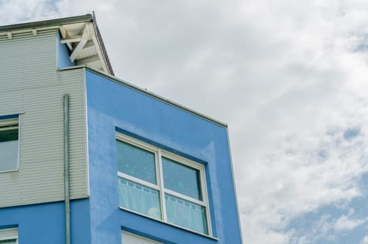 View of a house facade in blue of a newly built modern residential building.
