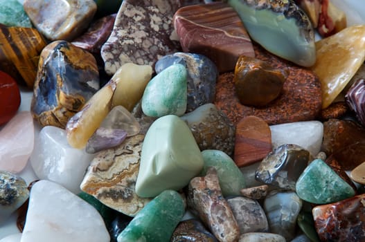 Close up of many different size, shape and colored tumbled stones
