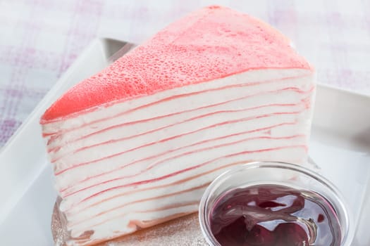 Close up crepe cake and blueberry sauce, stock photo