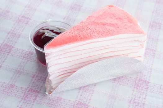 Pink crepe cake and blueberry sauce, stock photo