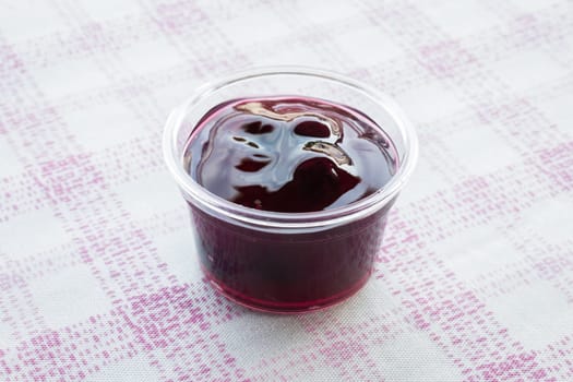 Cup of delicious blueberry sauce, stock photo
