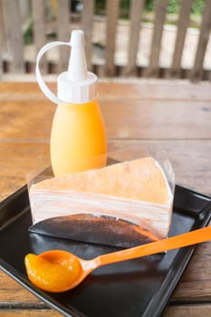 Whipped cream crepe cake with orange sauce, stock photo