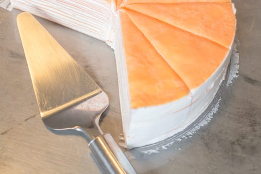 Piece of orange crepe cake, stock photo