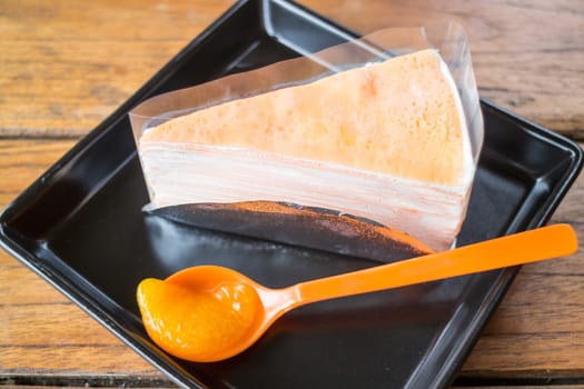 Whipped cream crepe cake with fresh orange, stock photo