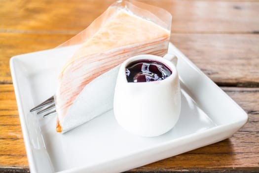 Whipped cream crepe cake with blueberry sauce, stock photo