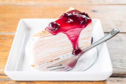 Delicious whipped cream crepe cake with blueberry sauce, stock photo