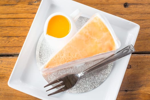 Orange whipped cream crepe cake on top view, stock photo