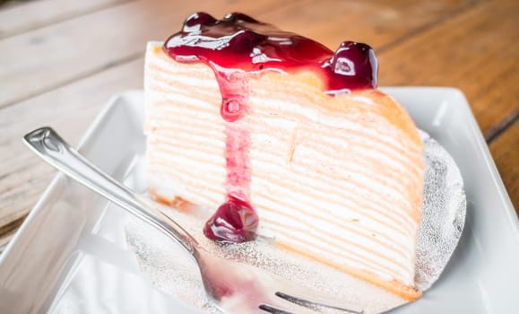 Delicious crepe cake with blueberry melt sauce, stock photo