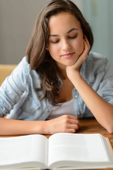 Beautiful student teenage girl enjoy reading book at home