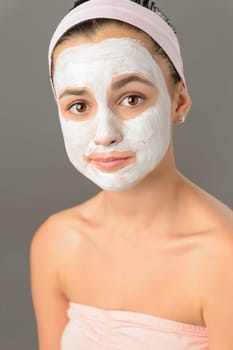 Sad teenage girl face mask skin beauty on gray background
