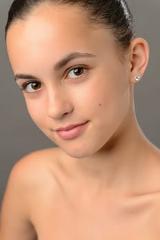 Teenage girl bare shoulders skin care beauty close-up gray shoulders