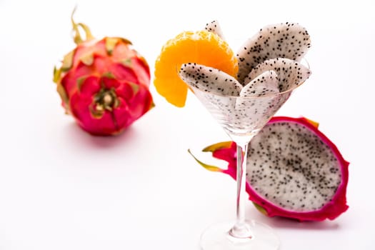 Wedges of the dragon fruit assorted in a long-stemmed glass and decorated with a mandarine slice,which also corresponds as regards taste..