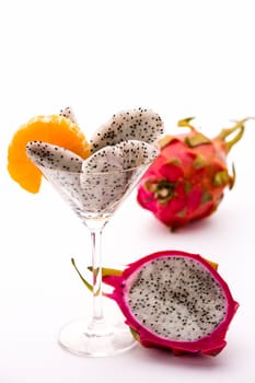Wedges of the dragon fruit assorted in a cocktail glass and adorned with mandarine disc,which is also in harmony as regards taste..
