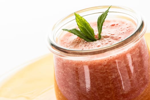 Red cold bowl with melon and peppermint in a glass