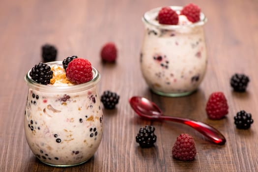 Yoghurt in glass with red and black fruits