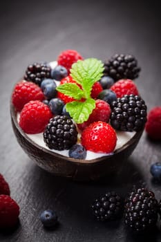 Coconut ice cream with fresh fruits and mint