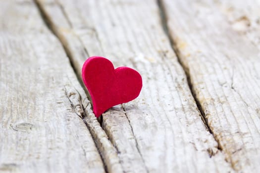 red heart on wooden background
