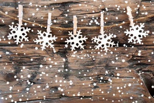 Wooden Snowflakes on a line with Snowflakes on Wood, Christmas or Winter Background