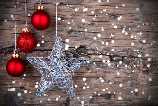 Christmas Background with red Christmas Balls and a Silver Christmas Star and Snowflakes