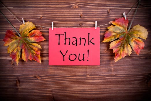 Red Label with Thank You with Autumn Leaves on a Line