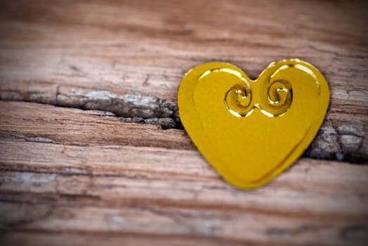 A Golden Heart on a Broken Wood Background