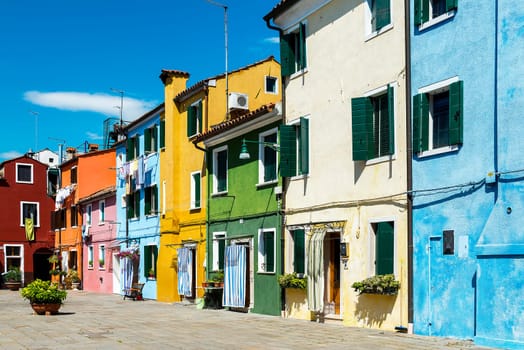 Colorful buildings in Burano island sunny street, Venise, Italy