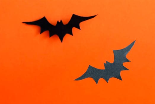 Two Black Bats as Halloween Background on Orange