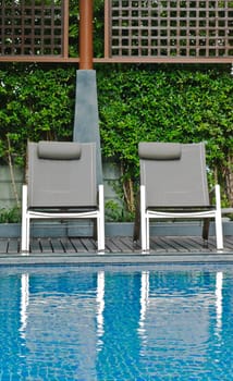 Swimming pool with two chairs