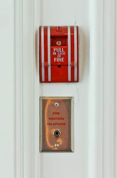 Fire alarm pull station on wall