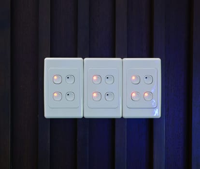 Light switch on wooden wall