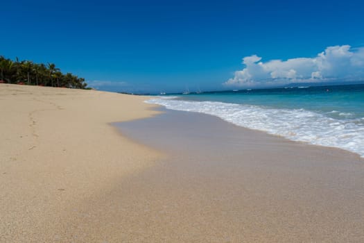 Beautiful secluded sandy beach in the Caribbean with white sand and blue sky as in paradise