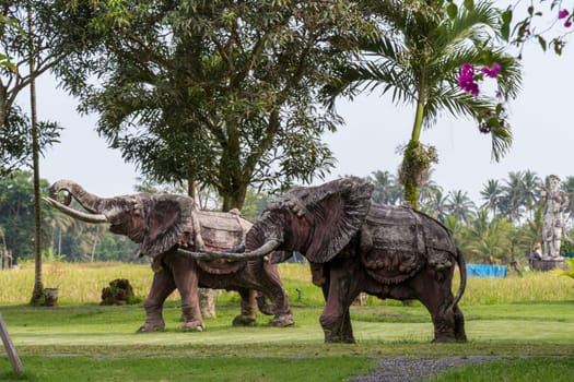 Realistic statue of a bronze elephant in a park in Bali