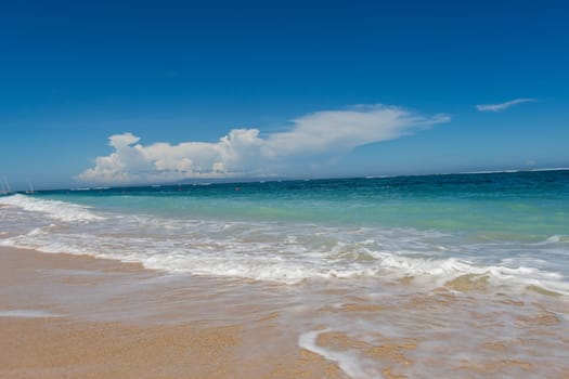 Beautiful secluded sandy beach in the Caribbean with white sand and blue sky as in paradise