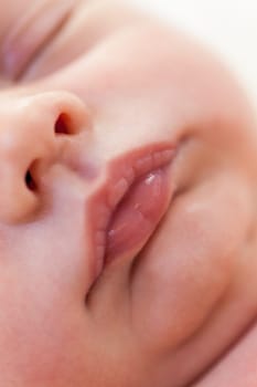 Little baby toddler newborn naked on a white fur as Detal
