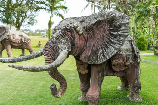 Realistic statue of a bronze elephant in a park in Bali
