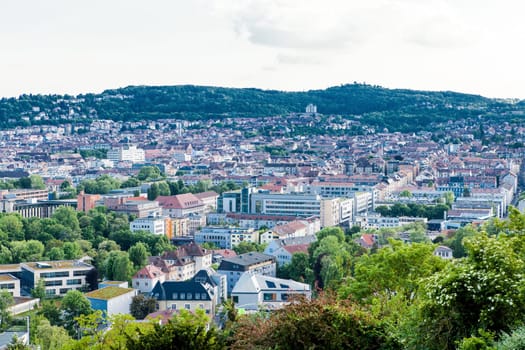 Picturesque view of Stuttgart Germany the modern skyscrapers under the traditional historical architecture overlooking the surrounding hills on a sunny day