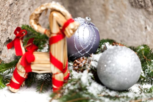 Silver Christmas bauble jewelry with deer and fir branches decoration for Christmas as macro detail