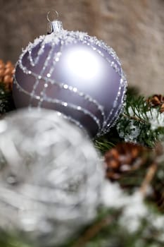 Silver Christmas bauble jewelry with deer and fir branches decoration for Christmas as macro detail