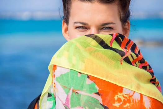 Young pretty woman with dark hair in bikini and Pareo on vacation on the beach portrait