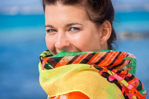 Young pretty woman with dark hair in bikini and Pareo on vacation on the beach portrait