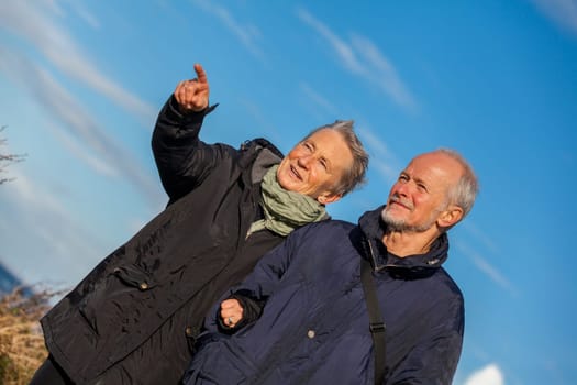 older seniors couple happy laughing in holiday leisure natural ostsee